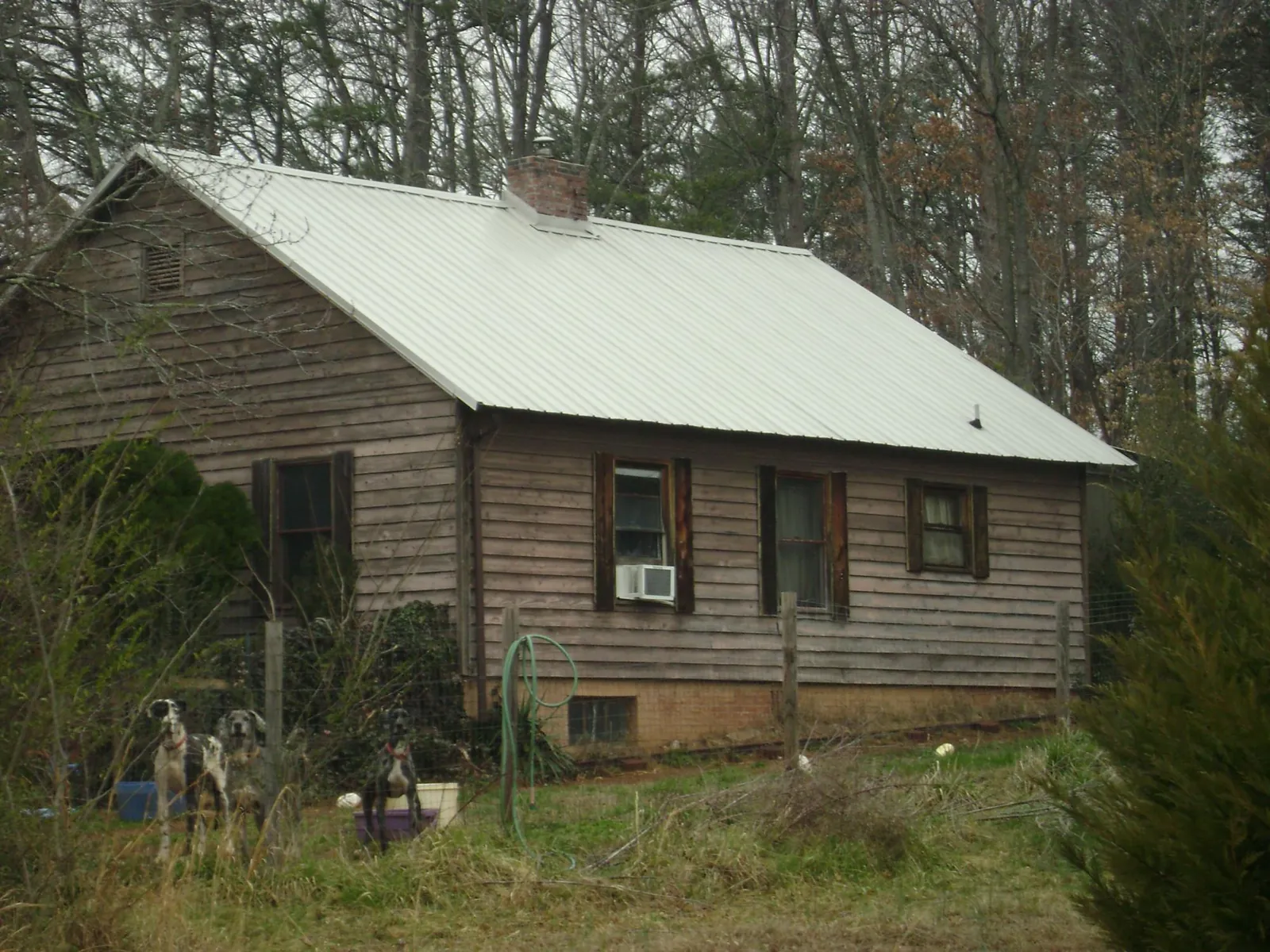 White metal roof on an old wood sided farmhouse, from a Metal Roof Installation job in Searsboro